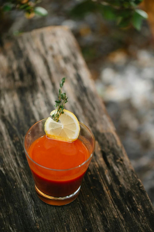 classic canadian caesar cocktail with lemon and herb garnish