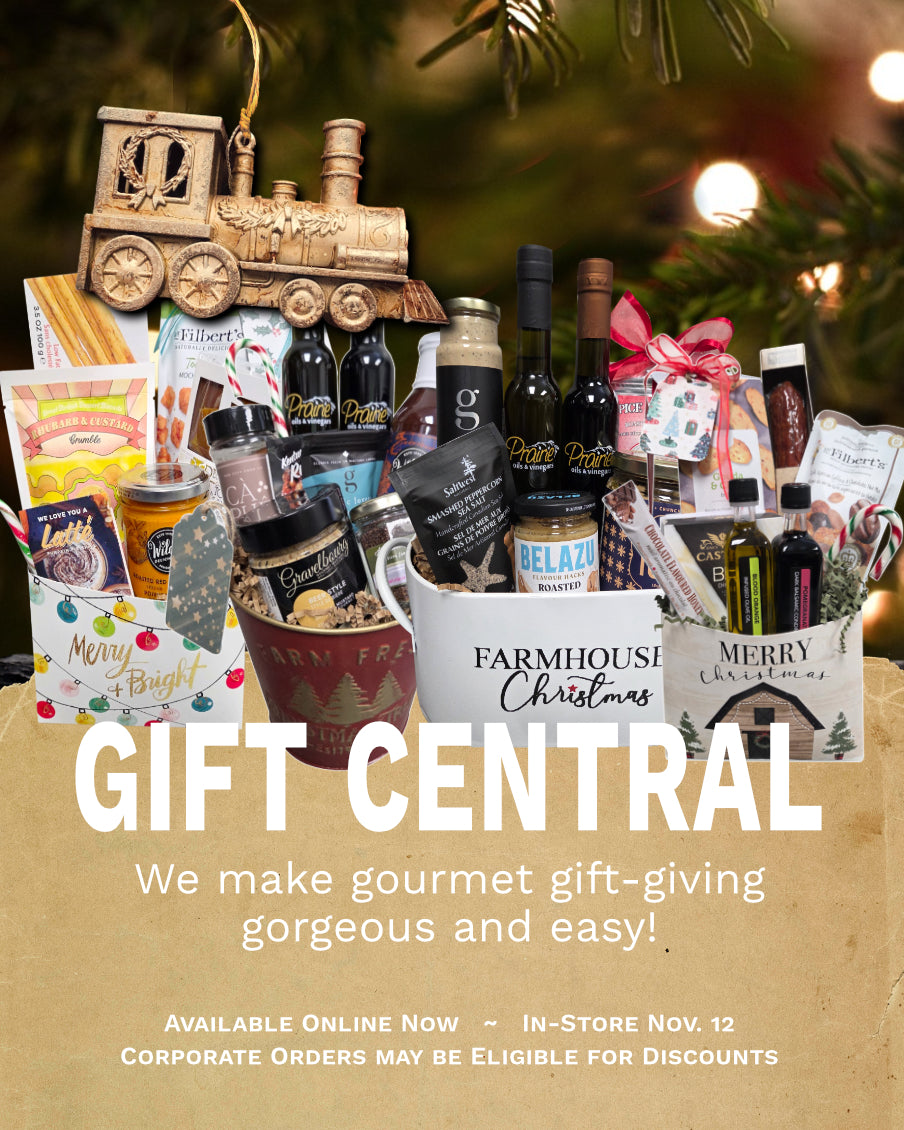 Gourmet gift basket with various items including bottles and snacks, featuring 'Farmhouse Christmas' theme.